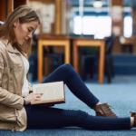 student-library-girl-reading-book-education-studying-literature-english-language-college-person-relax-floor-by-shelf-with-novel-knowledge-scholarship-learning-history_590464-397919